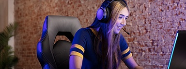 a girl wearing a headset looking at a monitor