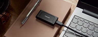 Kingston XS1000 external SSD plugged into a laptop