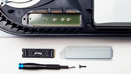 Um PS5 com a porta de SSD removida, um SSD FURY Renegade, uma chave de fenda e um parafuso