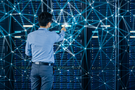 The Value of SDS man pressing a button on a server with symbolic network connection lines all around