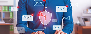 A person in an office using a keyboard. Superimposed, multiple email logos and a shield/lock logo.