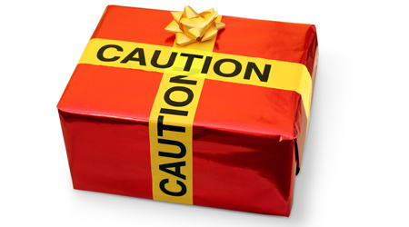 A gift wrapped box with caution tape used as a bow