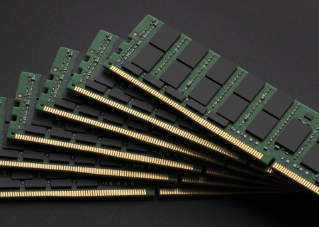 A stack of memory modules fanned out on a dark background