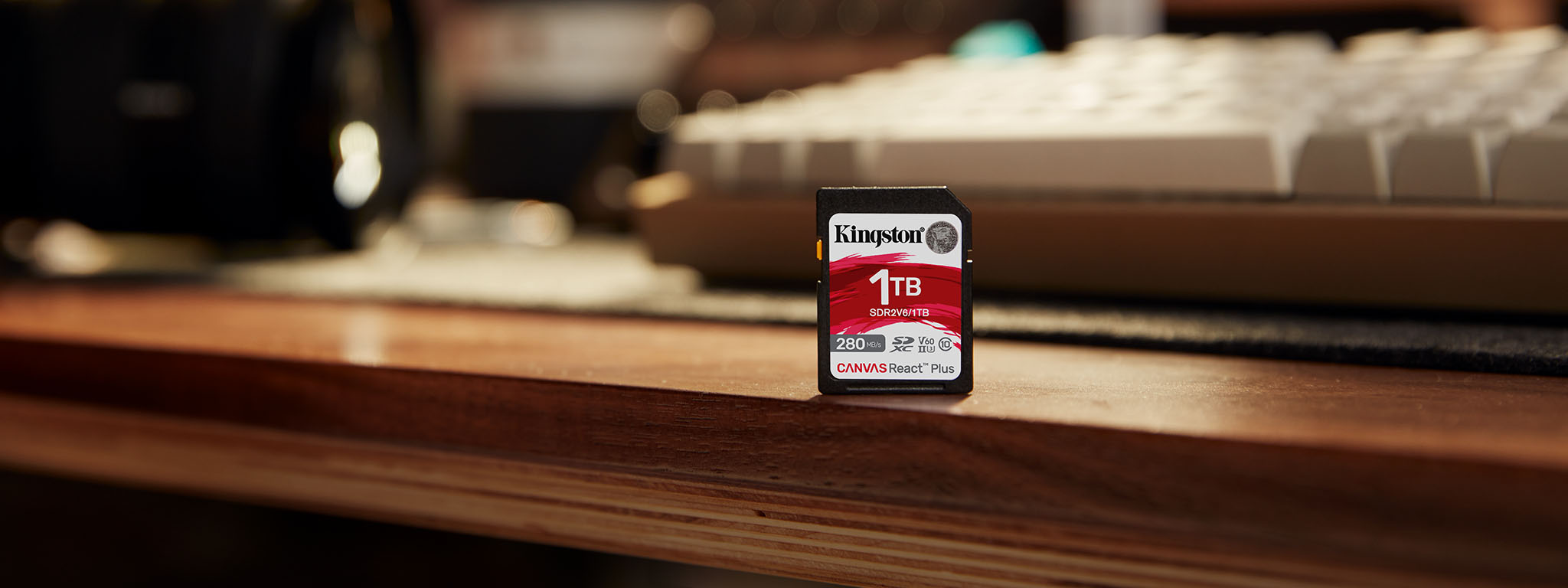 Canvas React Plus V60 SD Card sitting at the edge of a desk, 1TB capacity.