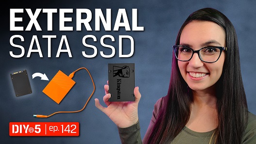 Trisha holding an SSD next to some external enclosures