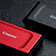 Two XS1000 external SSDs sit on a desk, one is black, the other is red 