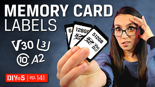 Trisha holding memory cards with labels on them like V30, U3, Class 10, A2.