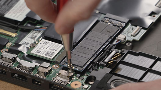 Close-up of an M.2 SSD being installed in a laptop